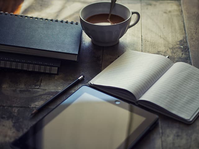 Open diary and stationery in a calm, neutral flat lay