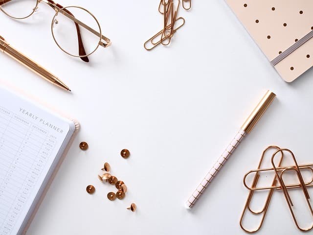 Flat-lay of planner pages, notebook and a coffee